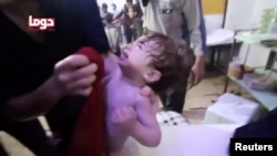 A child cries as they have their face wiped following alleged chemical weapons attack, in what is said to be Douma, Syria in this still image from video obtained by Reuters on April 8, 2018.