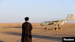 FILE PHOTO: An Iranian cleric stands near a drone during a military exercise in an undisclosed location in Iran