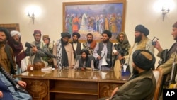 Taliban fighters take control of Afghan presidential palace after the Afghan President Ashraf Ghani fled the country, in Kabul, Afghanistan, Sunday, Aug. 15, 2021. (AP Photo/Zabi Karimi)