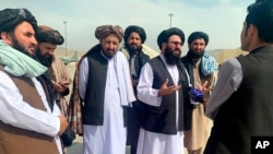 Taliban officials are interviewed by journalists inside the Hamid Karzai International Airport after the U.S. withdrawal in Kabul, Afghanistan, Aug. 31, 2021.