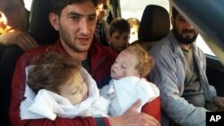 Abdul-Hamid Alyousef, 29, holds his twin babies who were killed during a suspected chemical weapons attack, in Khan Sheikhoun in the northern province of Idlib, Syria, April 4, 2017.