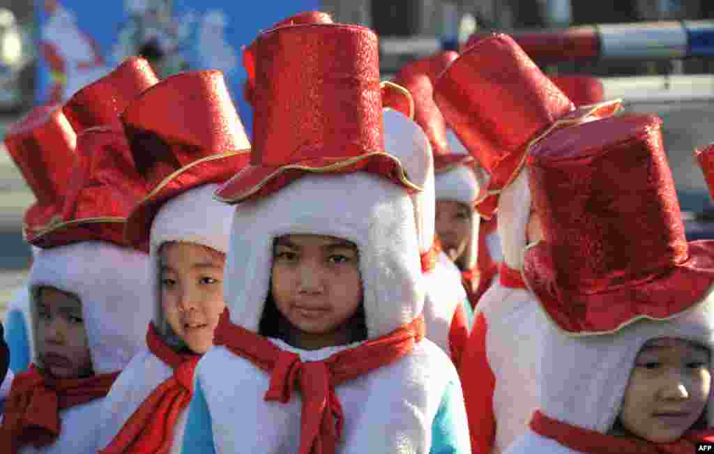 Children dressed as snowmen take part in a New Year's parade in the Kyrgyz capital Bishkek on December 31, 2014. New Year, which was the biggest informal holiday of the year in the former Soviet Union, is also very popular in the predominantly Muslim Cent