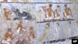 This image taken from video, Feb. 3, 2018, shows wall paintings inside a 4,400-year-old tomb near the pyramids outside Cairo, Egypt. Egypt's Antiquities Ministry announced the discovery Saturday and said the tomb likely belonged to a high-ranking official