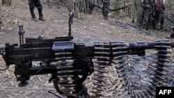 Karen National Union (KNU) soldiers stand guard with their assault weapons at Oo Kray Kee village in Karen State near Thai-Myanmar border on January 30, 2012. The Karen National Union (KNU) is waging the world's longest-running insurgency, launched 63 yea