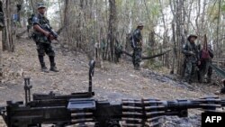 Karen National Union (KNU) soldiers stand guard with their assault weapons at Oo Kray Kee village in Karen State near Thai-Myanmar border on January 30, 2012. The Karen National Union (KNU) is waging the world's longest-running insurgency, launched 63 yea