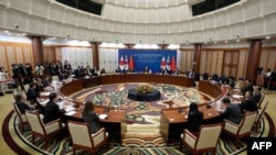 Delegates from South Korea (C), China (R) and Japan (L) attend the 10th trilateral foreign ministers' meeting in Busan on November 26, 2023.