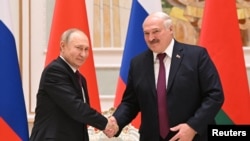 Russian President Vladimir Putin and Belarusian President Alexander Lukashenko attend a news conference in Minsk