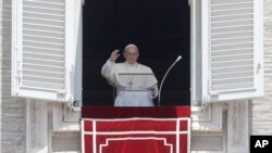 Pope Francis waves to faithful during the Angelus noon prayer in St. Peter's Square at the Vatican, June 3, 2018.