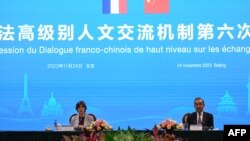 Chinese Foreign minister Wang Yi (R) and French Foreign minister Catherine Colonna attend the 6th China-France high-level dialogue on people-to-people exchange at Peking University in Beijing on November 24, 2023.