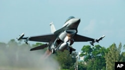 FILE - A Taiwanese Air Force F-16 fighter jet takes off from a closed section of highway during the annual Han Kuang military exercises in Chiayi, central Taiwan, Sept. 16, 2014.