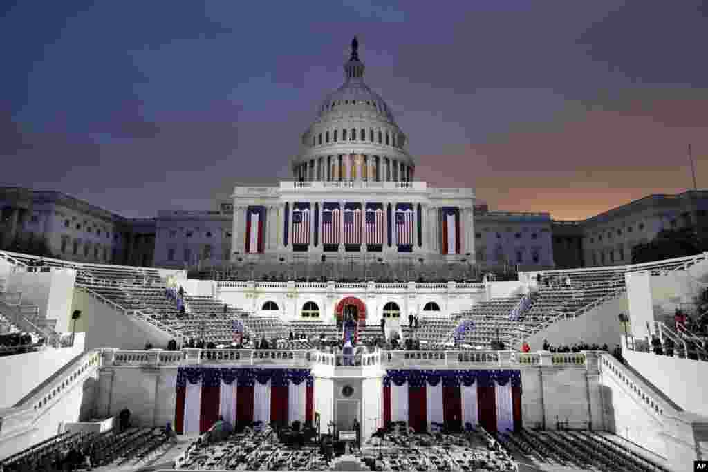 Dawn breaks behind the Capitol Dome as last minute preparations continue for swearing in of Donald Trump as the 45th President of the United States, Jan. 20, 2017.