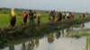 Displaced Rohingya refugees from Rakhine state in Myanmar carry their belongings as they flee violence, near Ukhia, near the border between Bangladesh and Myanmar on September 4, 2017. - A total of 87,000 mostly Rohingya refugees have arrived in Banglades