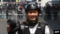 This picture taken on February 26, 2021 shows Associated Press (AP) photographer Thein Zaw posing for a photo during his coverage of demonstrations by protesters against the military coup in Yangon, a day before he was arrested. (Photo by STR / AFP)