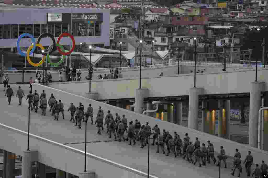 Soldiers pass by the Olympic rings in the Maracana Stadium prior to the opening ceremony for the 2016 Summer Olympics in Rio de Janeiro, Brazil,Aug. 5, 2016.