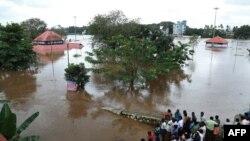 Indian residents look at the Shiva Temple submerged after the release of water from Idamalayar dam following heavy rains in Kochi on Aug. 9, 2018.