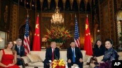 President Donald Trump and Chinese President Xi Jinping, sit with their wives, first lady Melania Trump, left, and Chinese first lady Peng Liyuan, right, before a meeting at Mar-a-Lago, Thursday, April 6, 2017, in Palm Beach, Fla. (AP Photo/Alex Brandon)