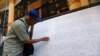 A man searches for his name through lists of voters outside an election commission office in Yangon November 4, 2010. Myanmar will hold its first parliamentary election in two decades on November 7, although critics say it will simply cement the military'