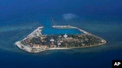 The Vietnamese-claimed Southwest Cay island in the Spratly island group is seen from a Philippine Air Force C-130 transport plane during the visit to the Philippine-claimed Thitu Island by Defense Secretary Delfin Lorenzana, Armed Forces Chief Gen.