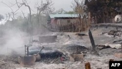 FILE - This handout from Pauk Township News taken and released June 16, 2021, shows the remains of houses after they were burnt by Myanmar soldiers in Kin Ma village, Pauk Township, in Myanmar's Magway region.