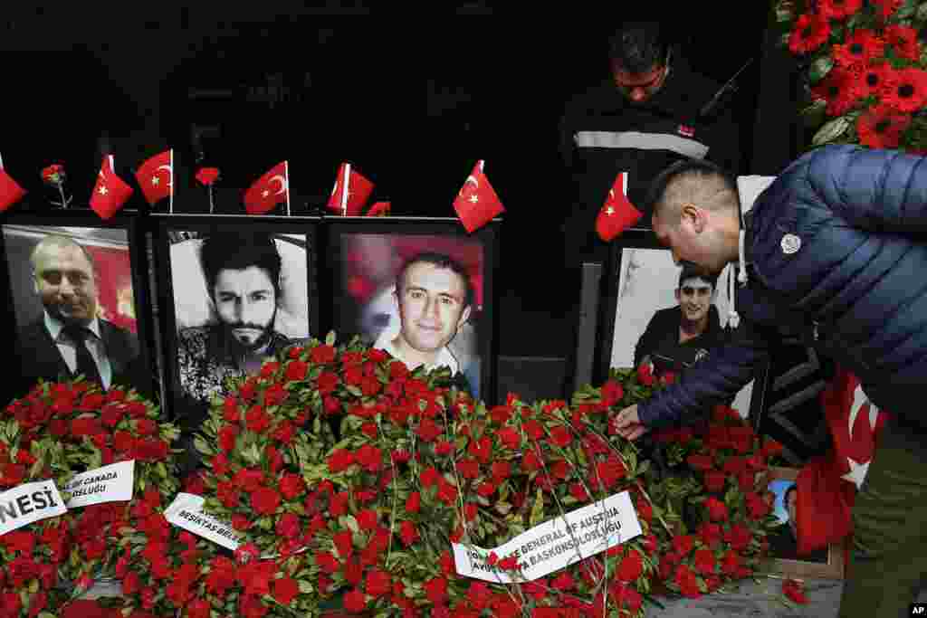 A man leaves a carnation outside Reina nightclub as people have gathered to remember the victims of a deadly New Year's attack a year ago, in Istanbul, Sunday Dec. 31 2017. Early on Jan. 1, 2017, an assailant shot his way into the Reina nightclub where hu