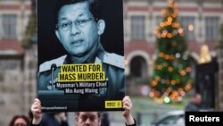 People demonstrate outside the International Court of Justice (ICJ), before the arrival of Myanmar's leader Aung San Suu Kyi for the second day of hearings in a case filed by Gambia against Myanmar alleging genocide against the minority Muslim Rohingya population, in The Hague.