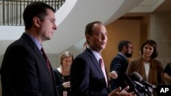 House Intelligence Committee Chairman Rep. Devin Nunes, listens at left, as the committee's ranking member Rep. Adam Schiff, D-Calif., talk to reporters on Capitol Hill, March 2, 2017. 