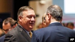 FILE - U.S. Secretary of State Mike Pompeo, left, speaks with Russia's Deputy Foreign Minister Igor Morgulov during the East Asia Summit Foreign Ministers Meeting on the sidelines of the 51st ASEAN Foreign Ministers Meeting in Singapore, Saturday, Aug. 4,