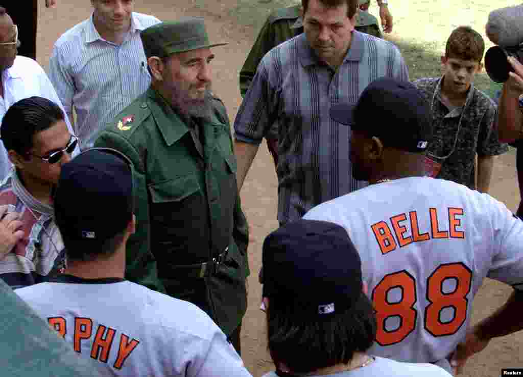 A March 28, 1999 file photo shows then-Cuban President Fidel Castro talking with Baltimore Orioles slugger Albert Belle (88) prior to the exhibition game between the Orioles and a Cuban National Team.