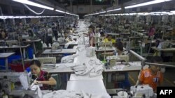 Employees work at the Shweyi Zabe garment factory i