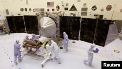 Technicians work on NASA's next Mars-bound spacecraft, the Mars Atmosphere and Volatile Evolution (MAVEN) spacecraft, as it is displayed for the media at the Kennedy Space Center in Cape Canaveral, Florida September 27, 2013. MAVEN is the first spacecraft