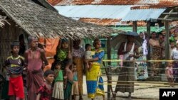 In this photograph taken on September 7, 2016, minority Muslim Rohingya gather at the Thet Kae Pyin displacement camp in Sittwe after the Rakhine State has been effectively split on religious grounds between Buddhists and Muslims since bouts of communal v