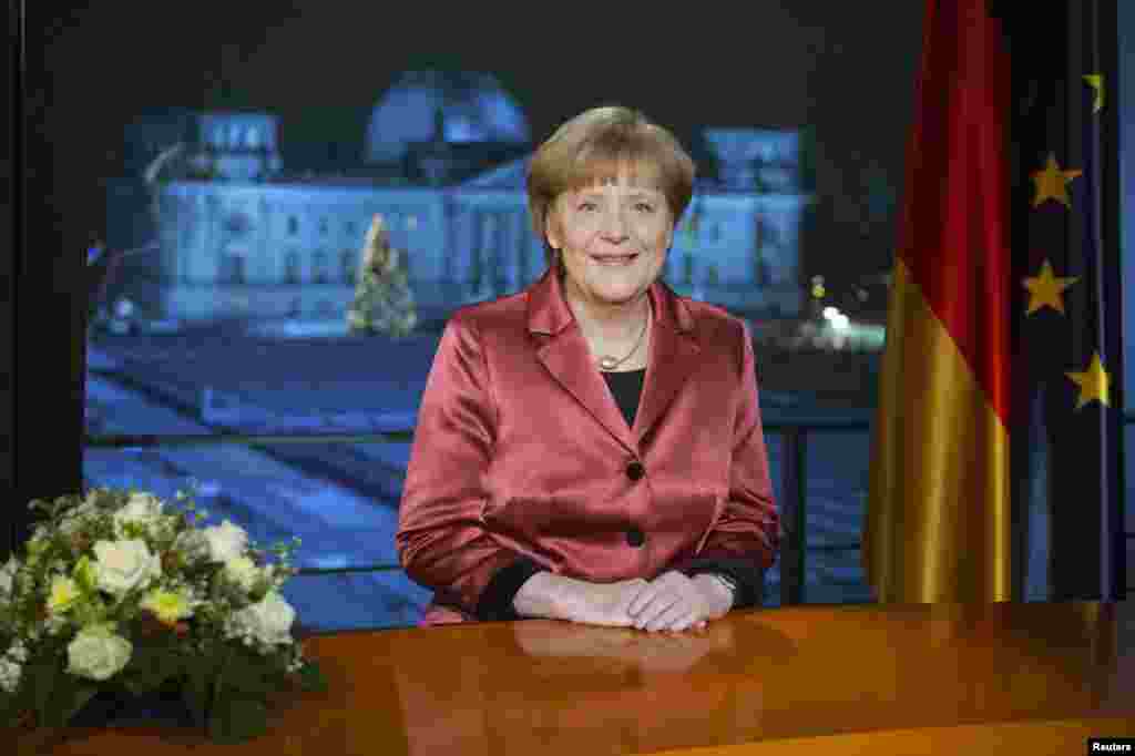 German Chancellor Angela Merkel concludes the recording of her New Year's speech in the Chancellery in Berlin, Dec. 30, 2014.